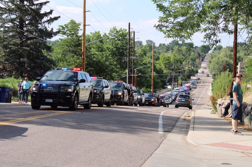 Police cars line up for the processional to honor the fallen APD officer.
